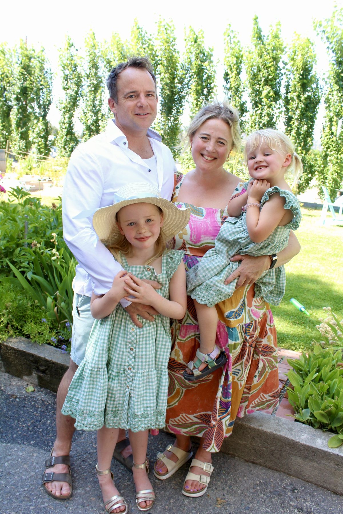 John Rousseau with his family in the garden on a summer afternoon.